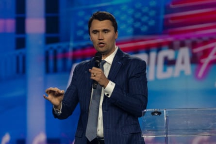 a man in a suit speaks on stage