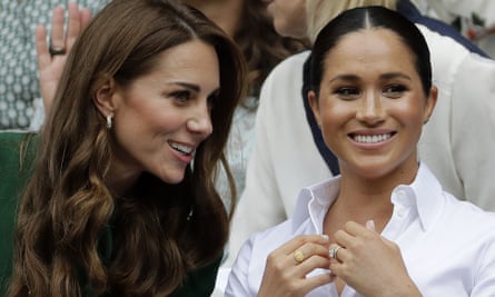 The Duchess of Cambridge (left) and the Duchess of Sussex chat in the royal box at Wimbledon’s Centre Court.