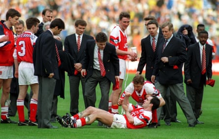Steve Morrow holds his arm after being dropped by Tony Adams during the celebrations.