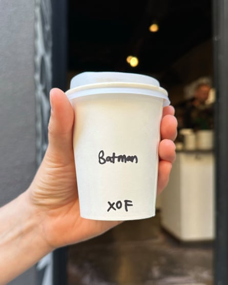 A takeaway coffee cup with the name Batman written on it