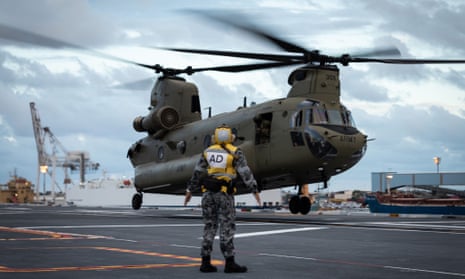The HMAS Adelaide embarks Australian army CH-47 Chinook heavy-lift helicopters before departing the Port of Brisbane in January 2022.