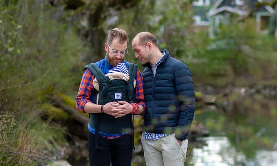 James, left, and Rob pose for a portrait with their son in Portland, Oregon