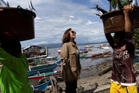 US vice-president Kamala Harris watches as fishers carry buckets of tuna at Tagburos village, a fishing community, in Puerto Princesa, Palawan, the Philippines on 22 November