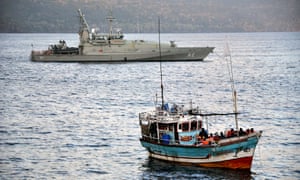 Asylum seekers who arrived by boat escorted by Australian navy patrol boats are moored at Christmas Island in 2012.