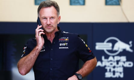 Christian Horner talks on his phone in the paddock as practice gets under way in Bahrain.