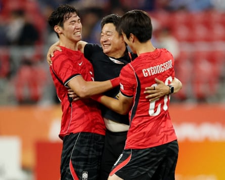 South Korea coach Lee Min-sung celebrates winning the gold with Lee Gi-hyuk (left) and Park Gyeong-seop