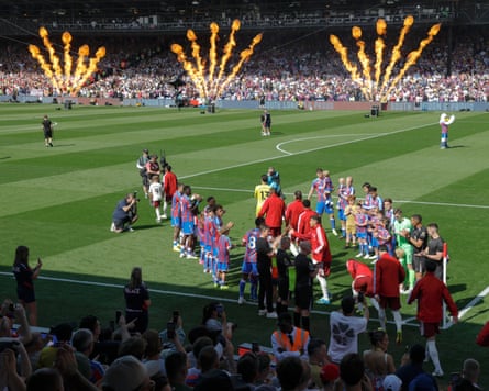 Crystal Palace’s players give Arsenal, the new Premier League champions, a guard of honour at Selhurst Park, with fire cannons firing in the background.