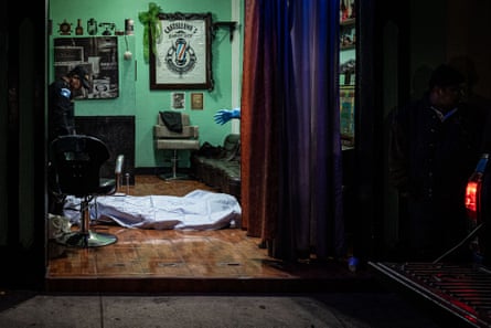 The police inspect the scene of the crime where Juan Carlos, 30, was executed in a hairdresser in San José Pinula