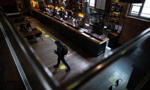 Yellow social distancing guides on the floor of the 256 bar.