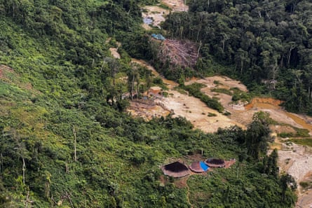 Aerial view of an illegal mining camp surrounding huts of an Indigenous tribe, at the Yanomami territory in Roraima State, Brazil