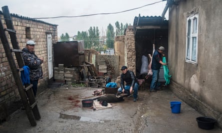 A family in Ak-Zhar slaughter a sheep ready for a pre-wedding party