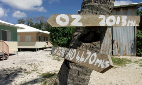 Signs pointing the way to Australia and New Zealand in Anaoe village on Nauru