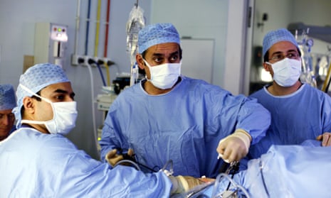 Lord Darzi, centre, performing surgery.