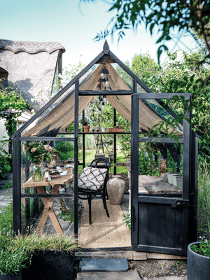 A rundown former greenhouse transformed to a garden room