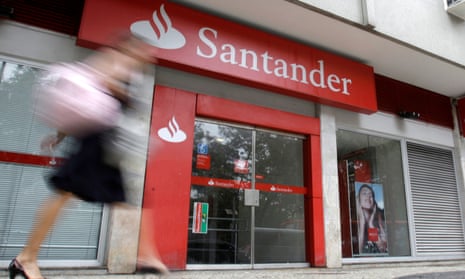 A woman walks past a Santander bank branch