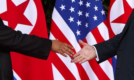 Donald Trump, right, reaches to shake hands with the North Korea leader, Kim Jong-un, on Sentosa Island in Singapore.