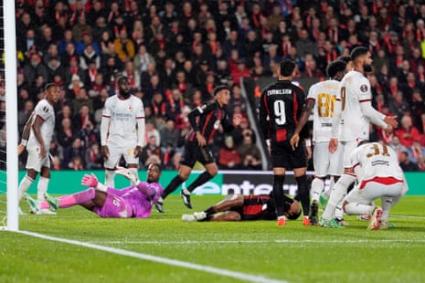 Bournemouth's Tyler Adams lies on the pitch as AC Milan's Mike Maignan and players gather round