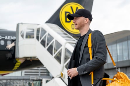 Marco Reus makes his way on to the flight to Paris.