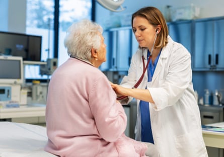 Female doctor listening senior woman’s breathing, heartbeats using a stethoscope