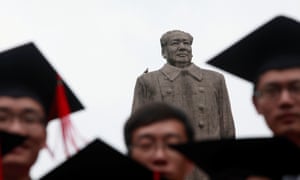 Graduates pose in front of a statue of the late Chinese leader Mao at Fudan University in Beijing.