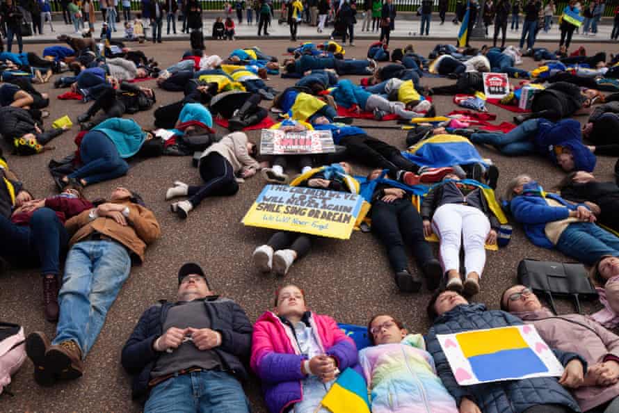 Protesters lie on the ground as they re-enact the murder of civilians in Bucha during a rally at the White House for Ukraine.