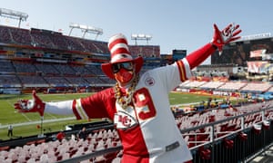 A Chiefs fan behind cutouts of fans in Raymond James Stadium