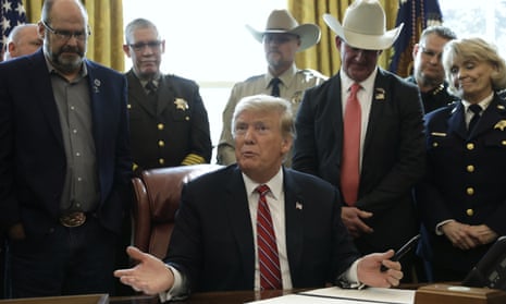 Trump vetoes Congress, surrounded by law enforcement officials.