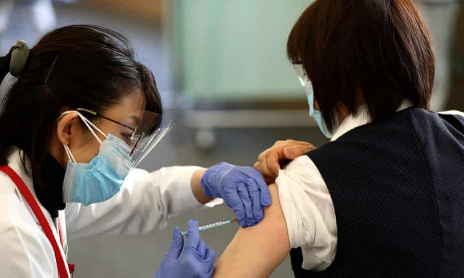 A woman receives the Covid-19 vaccinein Japan. One region might refuse to join in the Olympic torch relay over safety concerns.