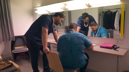 Tenors Pene Pati and Amitai Pati watch rugby backstage.