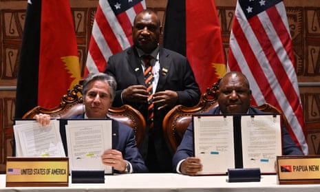 US Secretary of State Antony Blinken and Papua New Guinea's Defence Minister Win Bakri Daki show documents after signing a security agreement as Papua New Guinea's Prime Minister James Marape looks on