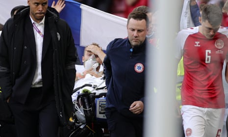 Christian Eriksen opens his eyes as he is stretchered from the field in Copenhagen.