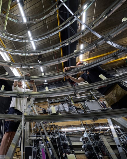 The giant chandelier is assembled backstage