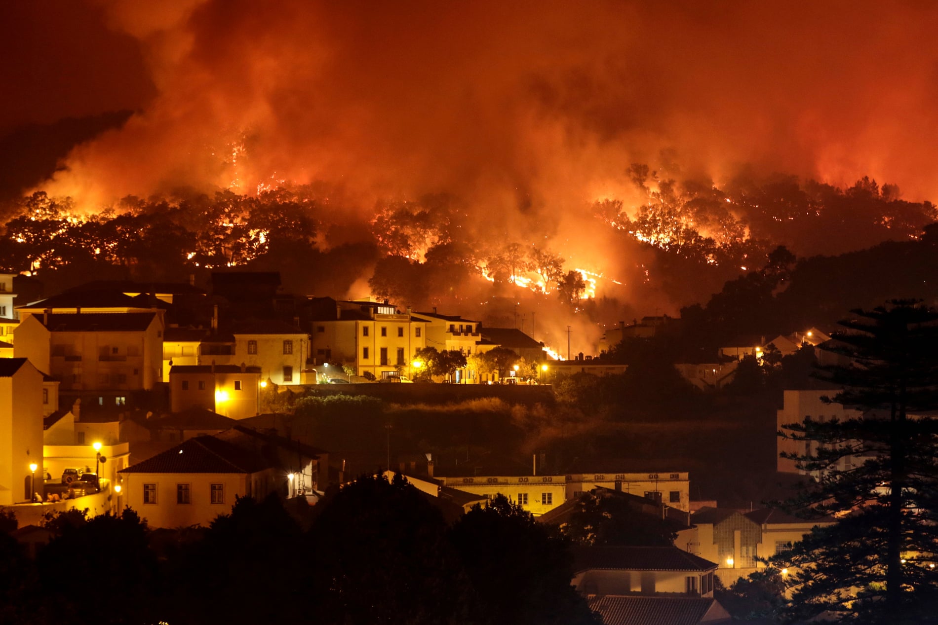 A forest fire burns on a hill in Monchique, Portugal, August 2018