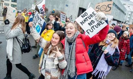 Students hold placards while shouting slogans during the demonstration in Brussels, 31 January. 