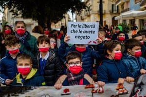Boys from schools in Puglia, Italy, hold signs in support of International Day for the Elimination of Violence Against Women