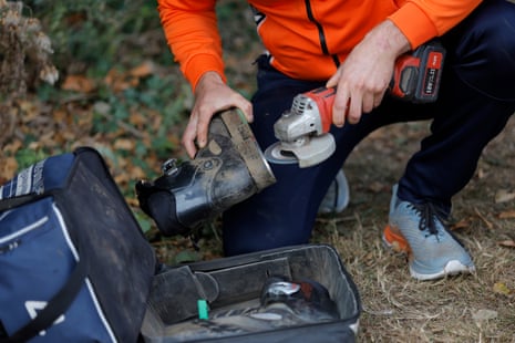 A Dutchman sharpens the edges on the steel plates attached to his tug of war boots.