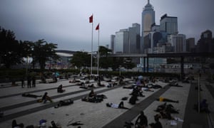 Protesters against a proposed extradition bill, rest near the Legislative Council building in the early morning in Hong Kong