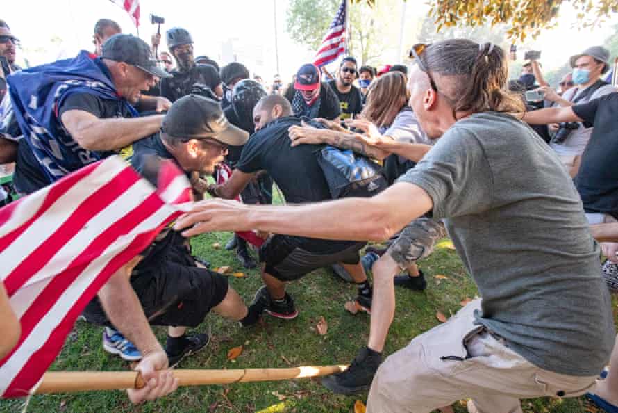 Donald Trump supporters clash with a Black Lives Matter supporter in Los Angeles, California, on Friday.