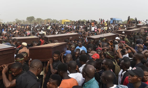 Pall bearers carrying the coffins of people killed during clashes between cattle herders and farmers earlier this month in Benue.
