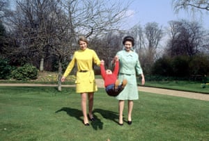 1968: Princess Anne and Queen Elizabeth II giving young Prince Edward a swing in the grounds of Frogmore