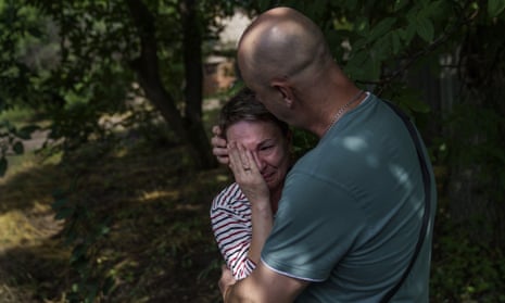 Havrysh, left, is comforted by her husband, Vadim, as she weeps while watching her elderly parents helped into a van to be evacuated to a safer part of the country in the west from their home in Kramatorsk, Donetsk region, eastern Ukraine, Tuesday, Aug. 2, 2022. “I understand that this will be the last time I ever see them,” she said. “You see their age, I can’t give them the proper care.” (AP Photo/David Goldman)