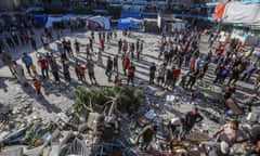 People search through rubble after the Israeli airstrike on an Unrwa-run school in Nuseirat