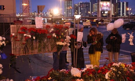People offer flowers in honor to the victims of the Crocus City Hall terrorist attack near the Crocus City Expo Complex on March 23, 2024 in Krasnororsk, Russia, on the outskirts of Moscow.