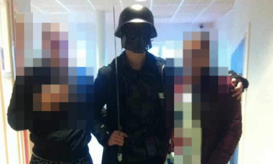 This picture, made available to AFP by a student, shows the masked man posing for a photo with pupils before the attack.