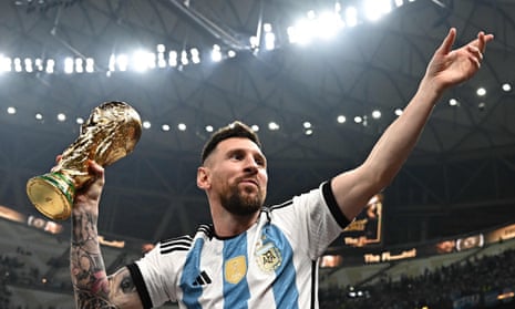 Lionel Messi poses with the FIFA World Cup Trophy after Argentina won the Qatar 2022 World Cup final.