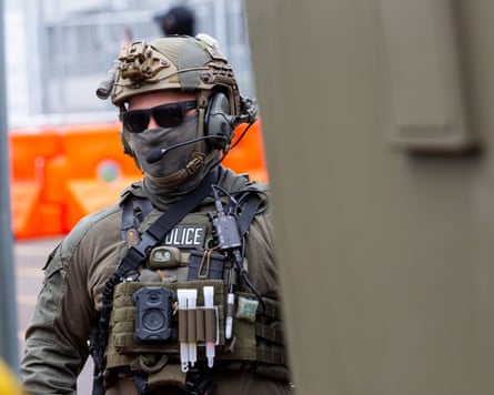 A federal agent wearing a helmet, mask and sunglasses