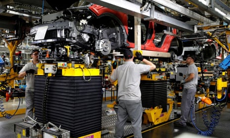 Workers are seen on the production line at Nissan’s car plant in Sunderland, Britain