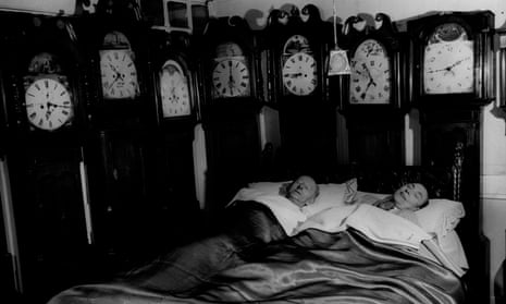 Mr and Mrs Charles Bromley of Belper, Derbyshire, at home with part of their collection of grandfather clocks, circa 1955. 