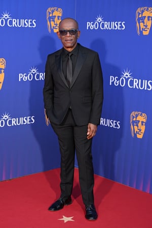 Lennie James in a black suit wearing sunglasses