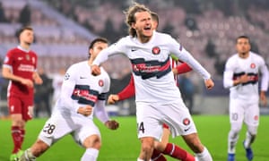 Alexander Scholz celebrates scoring a penalty for Midtjylland that earned the hosts a 1-1 draw with Liverpool.